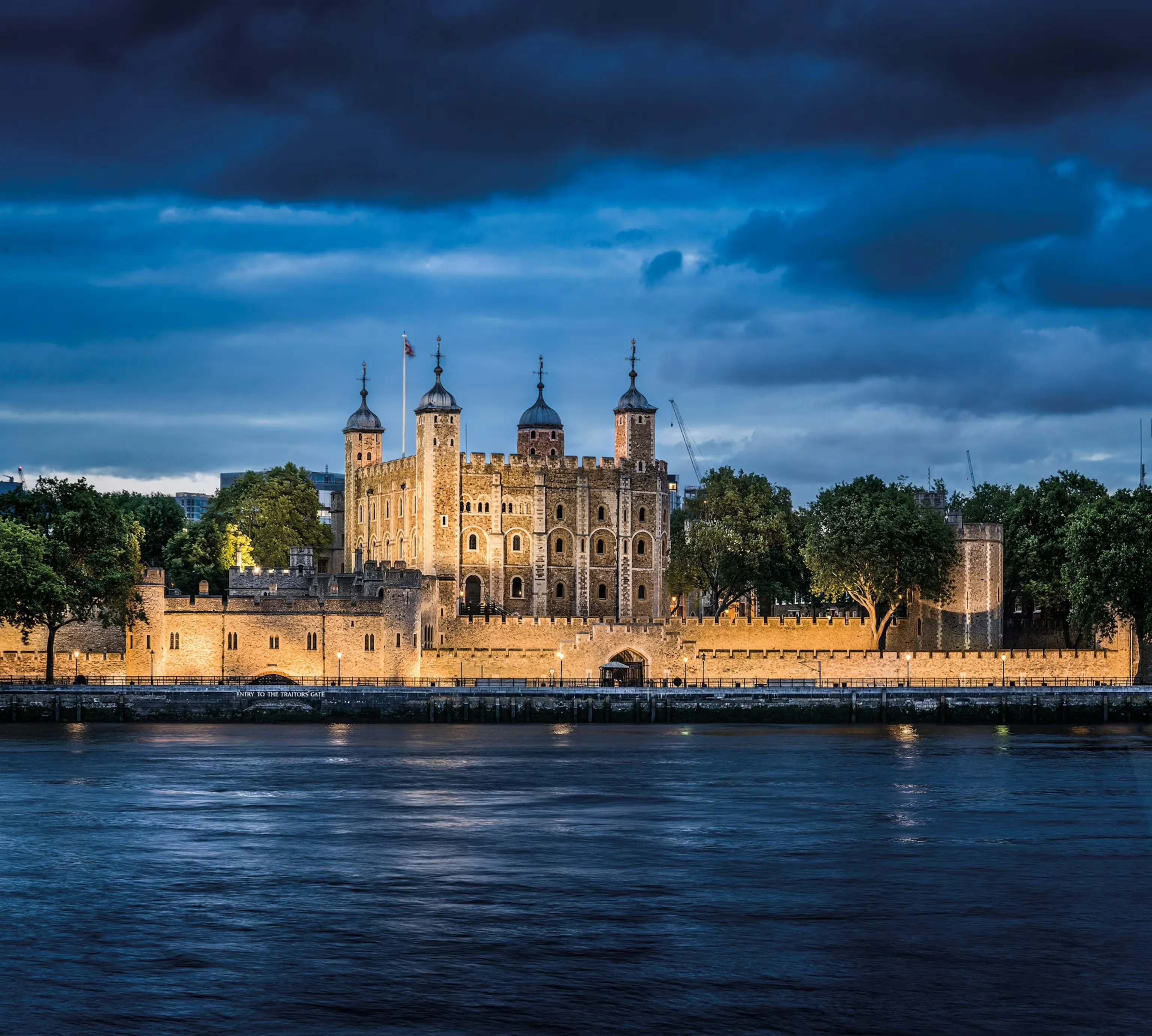 Evening lights on the Tower of London’s stone walls